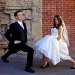 Calgary Wedding Photographer | Bride and Groom Stretching in alley