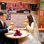 Calgary Wedding Photographer | Bride and Groom drinking a beer in the Palomino pub downtown calgary