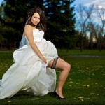 Calgary Wedding Photographer | Bride showing off garter on willow park golf course