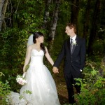 Calgary wedding photographer | Drumheller Wedding | Farm yard | Bride and Groom Holding hands in a forest