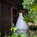 Calgary wedding photographer | Drumheller Wedding | Farm yard | Wedding dress shot, hanging on old farm house